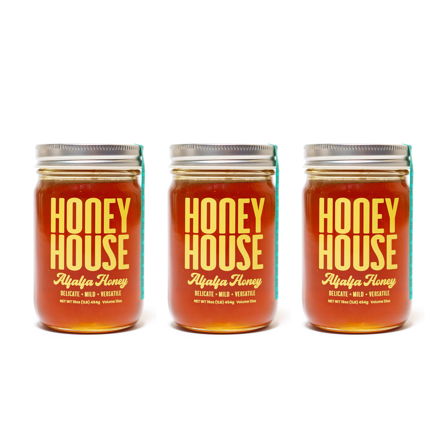 Three glass jars of Honey House Honey Alfalfa Honey, each with a silver lid and golden honey inside, are arranged side by side on a white background. The bold labels highlight the natural antioxidants in every jar.