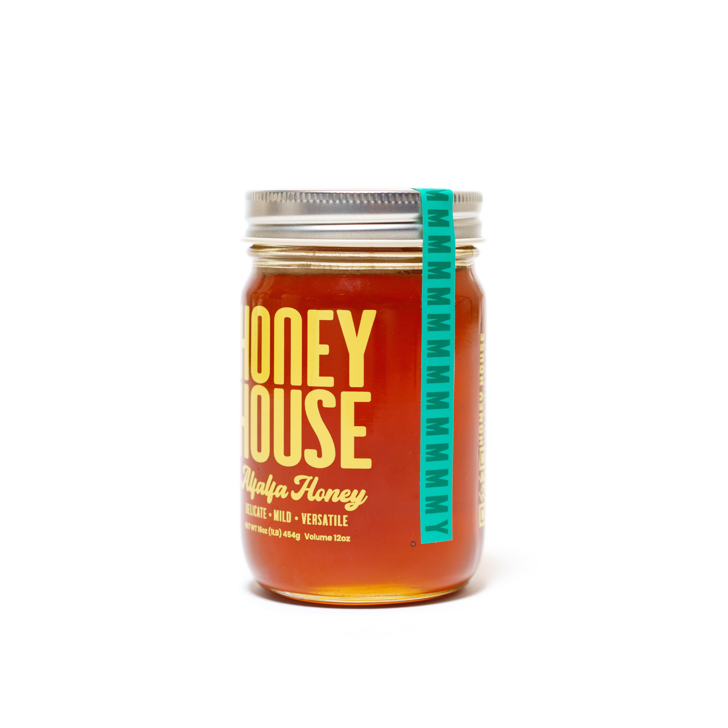A clear glass jar of Alfalfa Honey from Honey House Honey, sealed with a silver lid and blue tamper-evident strip—crafted in Colorado and rich in natural antioxidants.